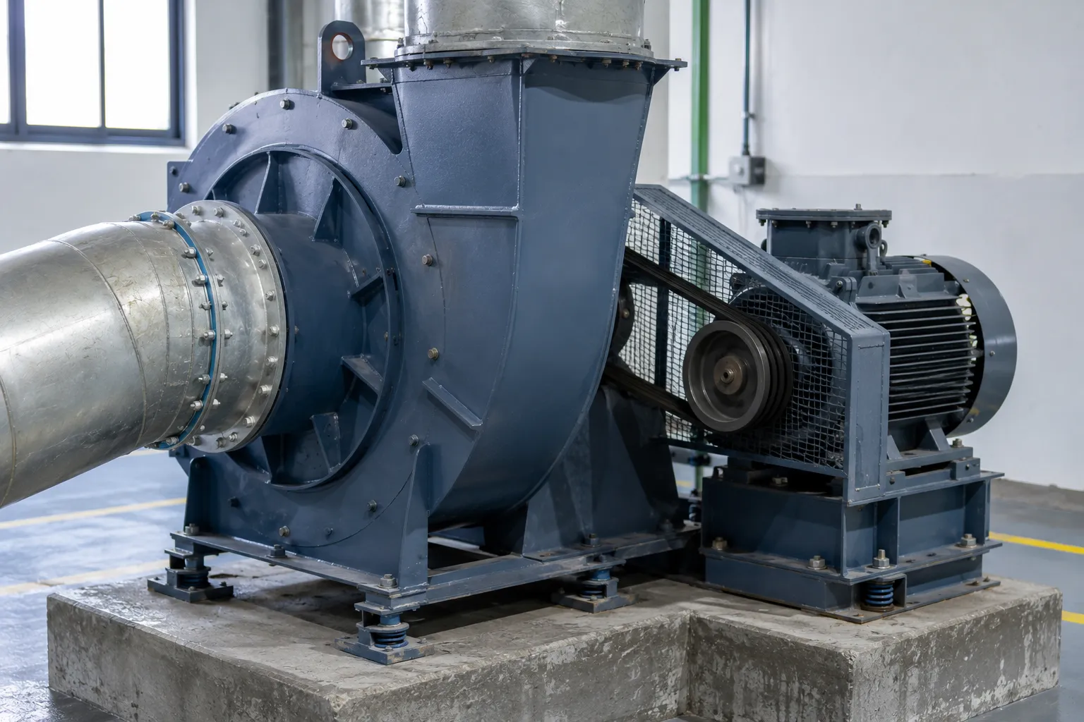 Forced draft FD fan supplying combustion air to a boiler inlet in an industrial facility.